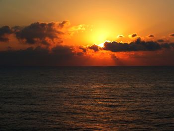 Scenic view of sea against orange sky