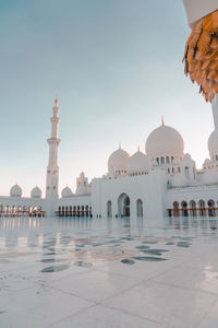 View of mosque in city against sky