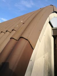 Low angle view of house roof against sky