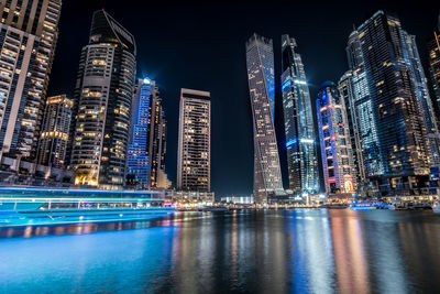 Illuminated modern buildings in city at night