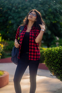 Young woman wearing sunglasses standing outdoors