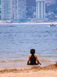 Rear view of boy on beach