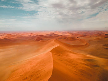 Scenic view of desert against sky during sunset