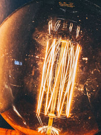 Close-up of illuminated light bulb at night