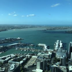 High angle view of buildings by sea against sky