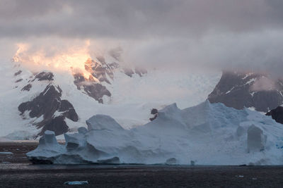 Scenic view of lake against mountain during winter