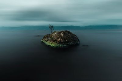 A lone rock near the coast of samosir island, lake toba, indonesia