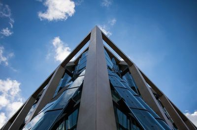 Low angle view of modern building against blue sky