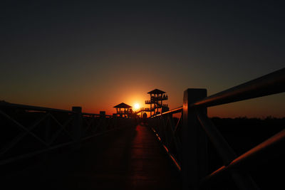 Silhouette bridge against sky during sunset