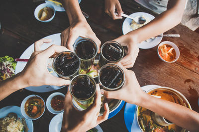 High angle view of people drinking glass on table