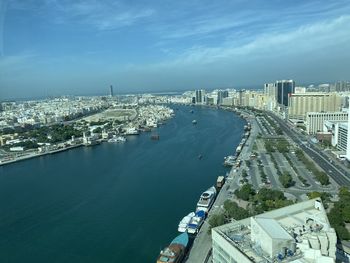 High angle view of buildings by sea against sky