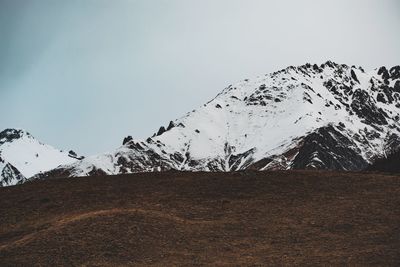 Scenic view of snowcapped mountains against clear sky