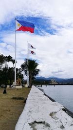 Scenic view of flag against sky