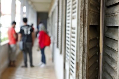 Rear view of woman walking in corridor