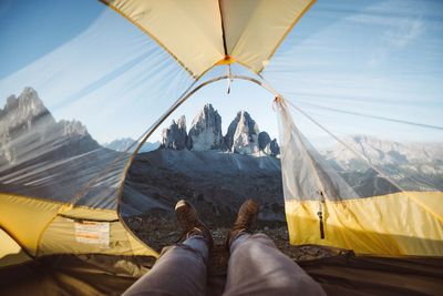 Low section of man lying in tent