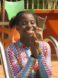 Side view of young woman sitting on stage