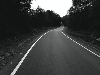 View of empty road along trees