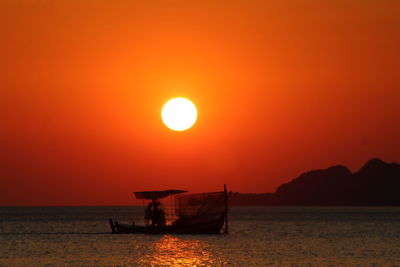 Scenic view of sea against orange sky