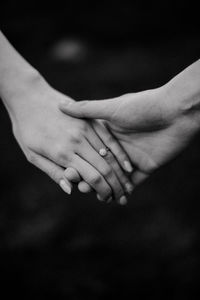 Cropped image of couple holding hands outdoors