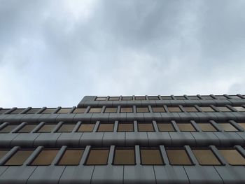 Low angle view of building against cloudy sky