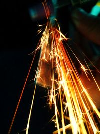 Low angle view of fireworks against sky at night