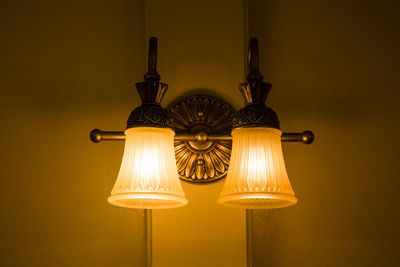 Low angle view of illuminated lamp at home