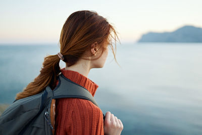 Portrait of woman in sea against sky