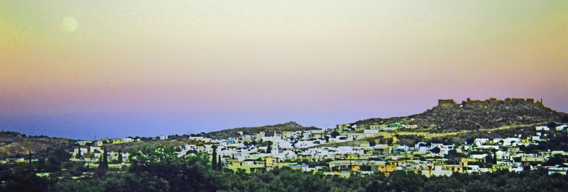 Houses in town against clear sky