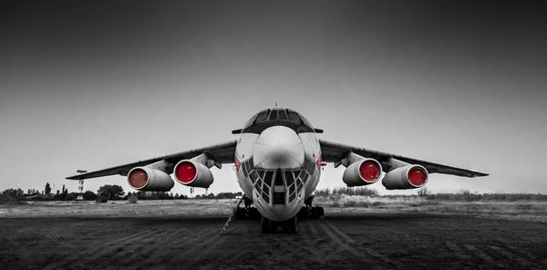 View of airplane on airport runway against sky