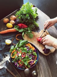 High angle view of person preparing food on cutting board