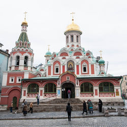 People at cathedral against sky