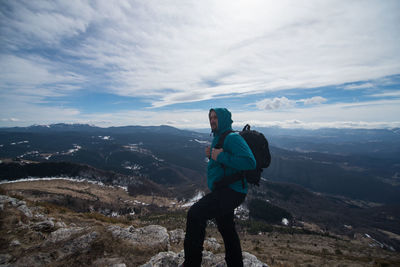 Full length of man standing on mountain against sky