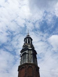 Low angle view of tower against cloudy sky