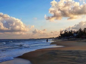 View of beach against cloudy sky
