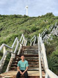 Portrait of smiling man sitting on staircase