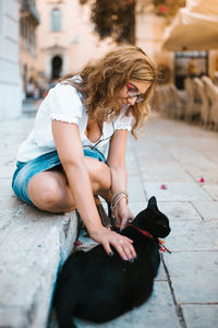 Woman with dog sitting outdoors