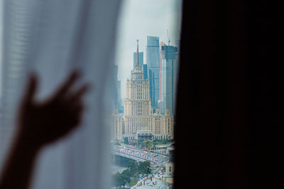 Low angle view of modern buildings seen through window