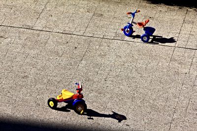High angle view of toy riding bicycle on street