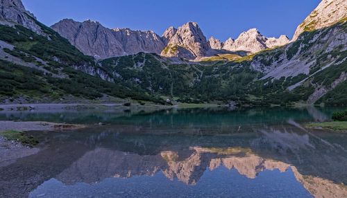 Scenic view of lake and mountains against sky