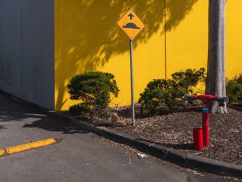 Road sign against yellow sky