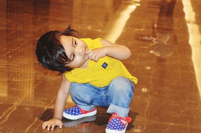 High angle view of girl sitting on floor