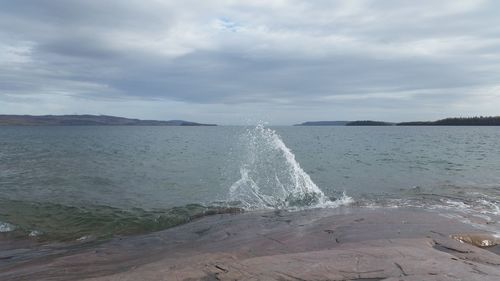 Scenic view of sea against cloudy sky