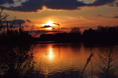 Scenic view of lake against sky during sunset