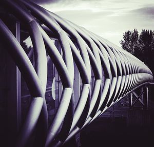 Close-up of metallic structure against sky