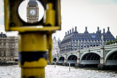 Westminster bridge over river thames against buildings in london city