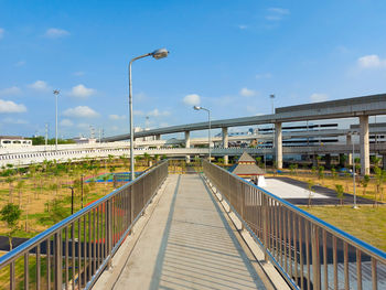 Footbridge over street against sky