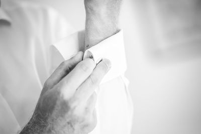 Cropped image of man buttoning sleeve