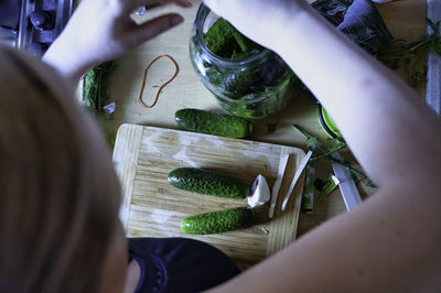 Close up of transparent glass jar with cucumber pickle before smoke from cooking in the kitchen