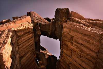 Low angle view of rock formations against sky