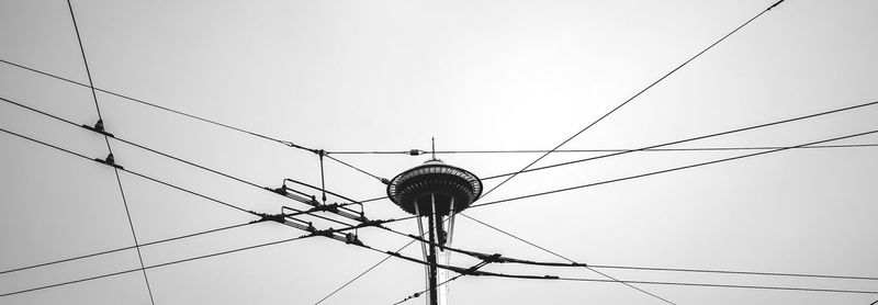 Low angle view of electricity pylon against sky